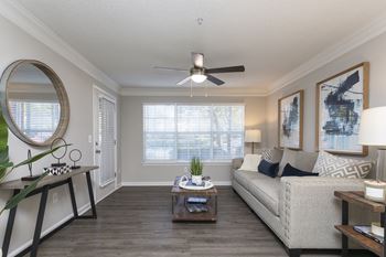 a living room with a ceiling fan and a large window at Crestmont at Thornblade, South Carolina, 29615